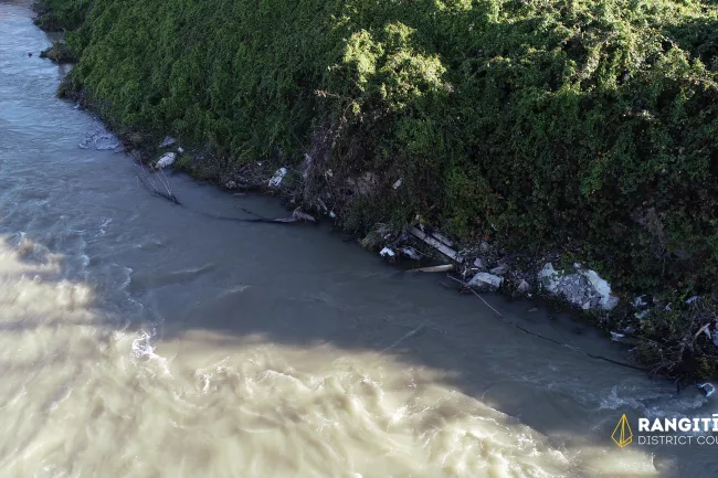 Image 2 - View of river edge, noting concrete and other debris.