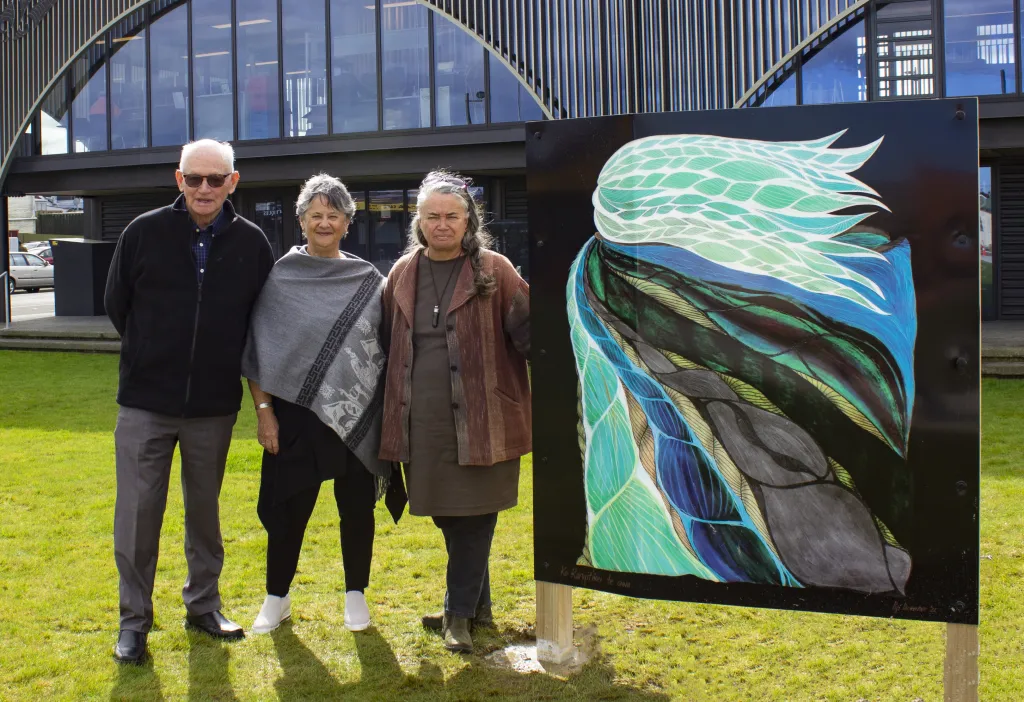 People standing around one of the outdoor artworks at Te Matapihi on the Town Square green space.