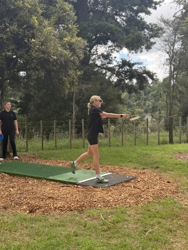 A student for Taoroa School throwing a frisbee disc from a tee on the new Taihape Disc Golf Course located at Memorial Park.