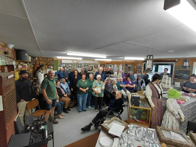 A group photo inside the Bulls Museum of the people who were there to support Alan and Fay with their Community Volunteer Award presentation by Mayor Andy Watson.